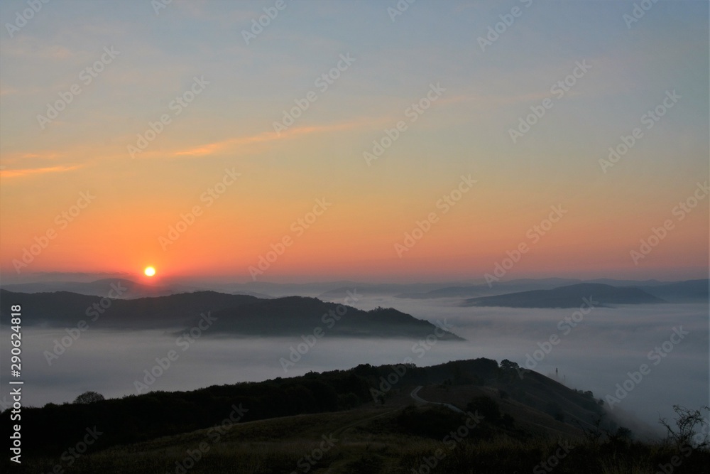 sunrise with fog between the hills sunrise with fog between the hills