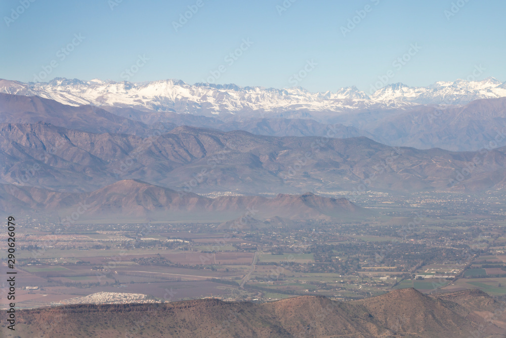 Aerial view of the Andes mountain range through the window of an airplane from Chile