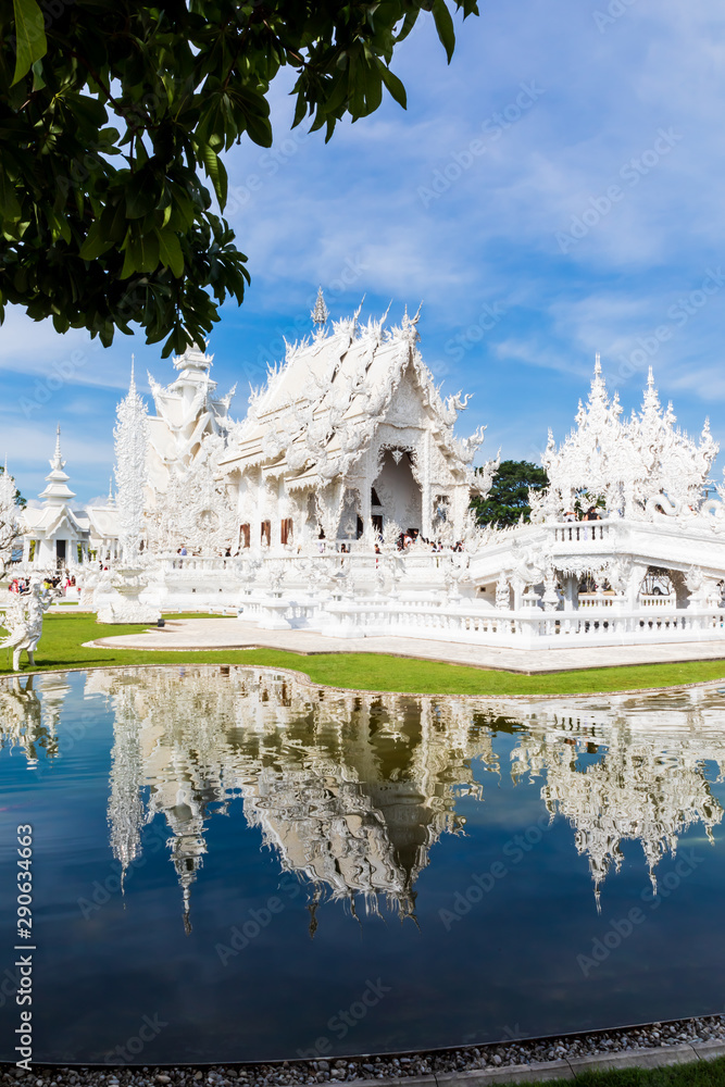Stunning view with water reflection of Buddhist temple Wat Rong Khun, better known to as the White Temple, in Chiang Rai Province, Thailand