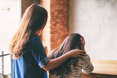 A woman comforting and giving encouragement to her sad friend
