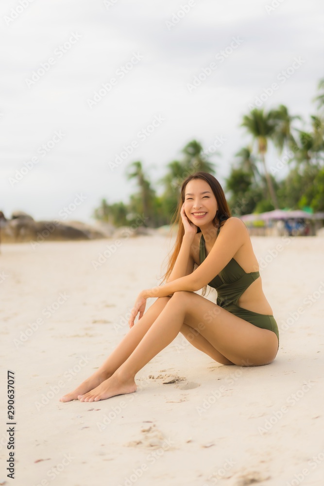 Portrait beautiful asian women happy smile relax on the tropical beach sea ocean