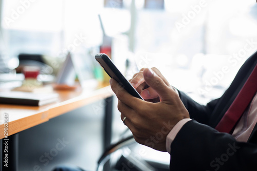 businessman hands searching for data on moblie phone with analyzing charts at his workplace.oncept