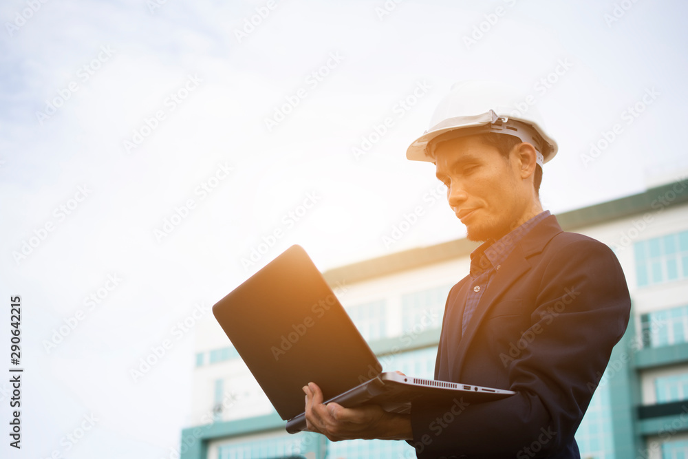 Engineer Notebook laptop work at  building sky background