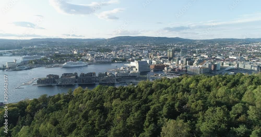 Cinema 4K drone shot with forward reveal motion and panorama view of the Oslo city tree line and construction in Bjoervika, a tourist attraction with the Munch museum, Soerenga and Barcode, in Norway. Cinema 4K drone shot with forward reveal motion and panorama view of the Oslo city tree line and construction in Bjoervika, a tourist attraction with the Munch museum, Soerenga and Barcode, in Norway.