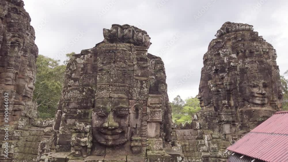 Bayon faces temple inside Angkor Thom complex. Daytime on a cloudy day. Bayon faces temple inside Angkor Thom complex. Daytime on a cloudy day.