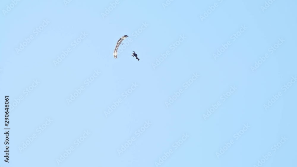 A man flying in the sky with opened parachute A man flying in the sky with opened parachute