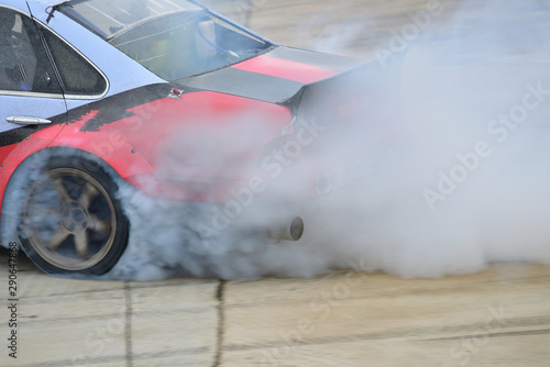Motion blur close up drift car with smoke from burning tires