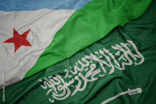 waving colorful flag of saudi arabia and national flag of djibouti.