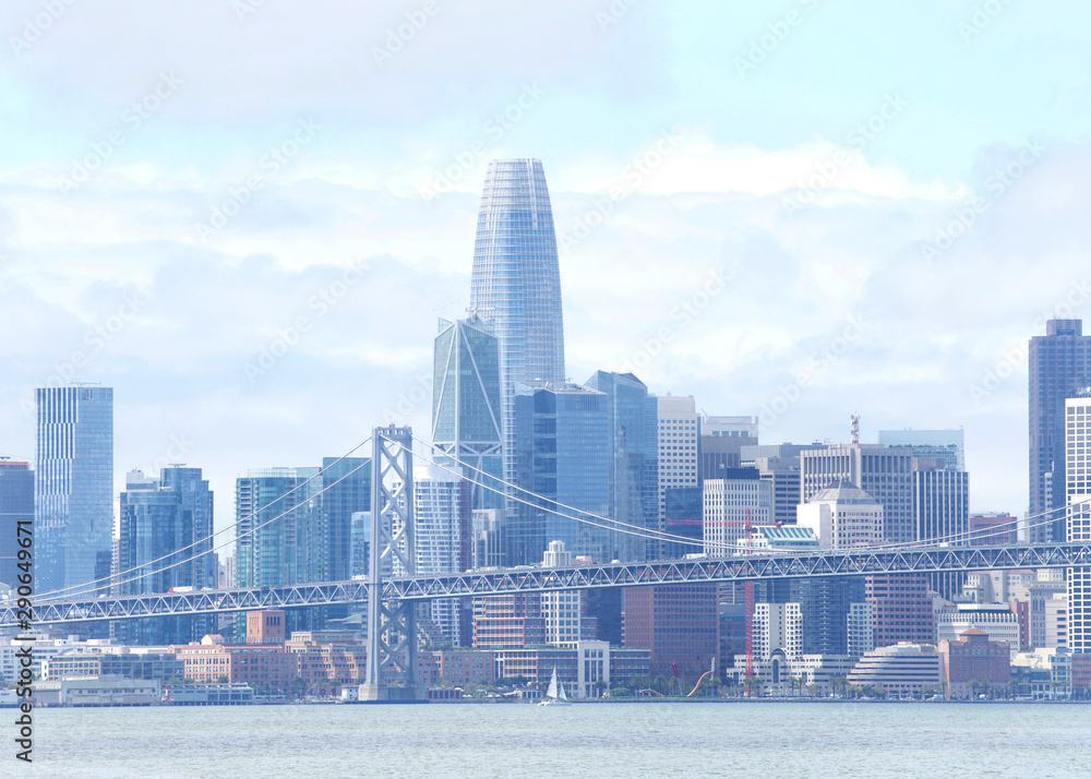 Fototapeta premium San Francisco city on a windy cloudy day with bay bridge foreground. As part of Interstate 80, the bridge connects San Francisco and Oakland, and carries about 260,000 vehicles a day.