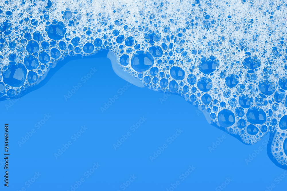 Bubble foam soap shampoo on blue water surface texture background top