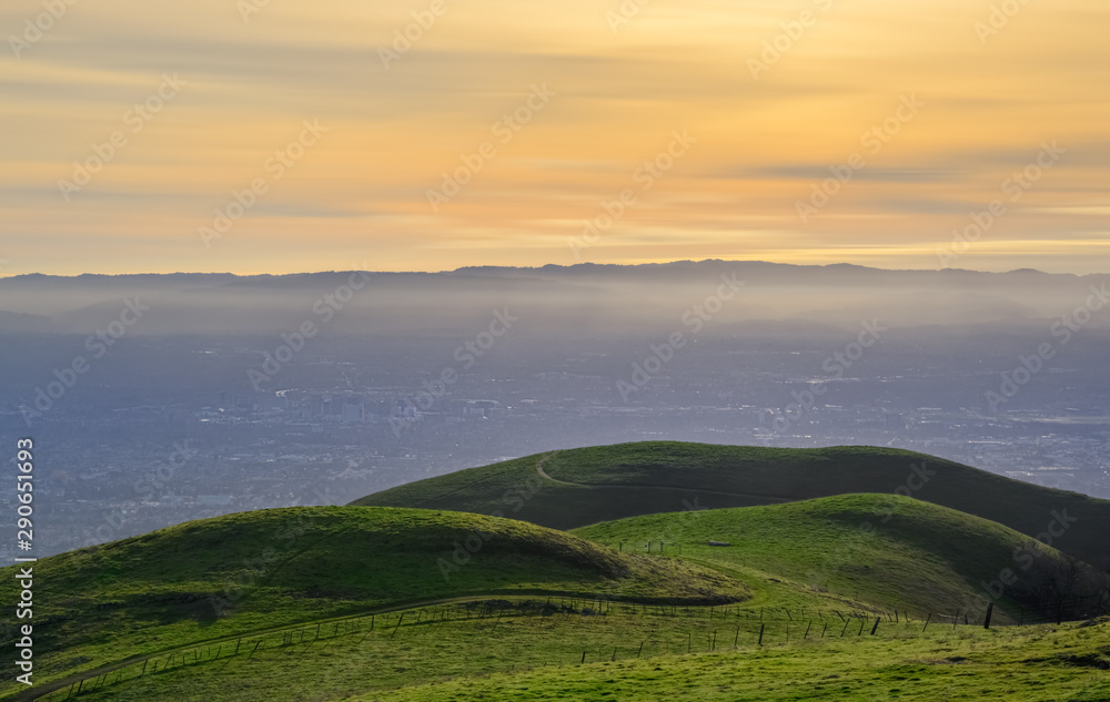 Sunset over green meadows