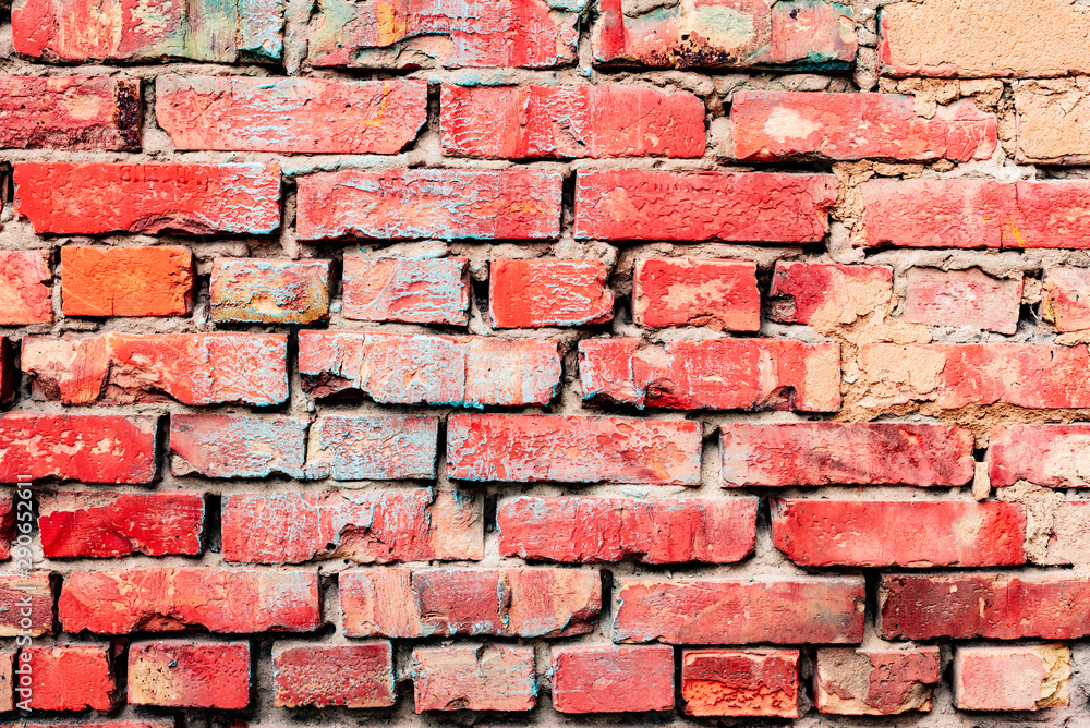 Texture of a brick wall with cracks and scratches which can be used as a background Texture of a brick wall with cracks and scratches which can be used as a background