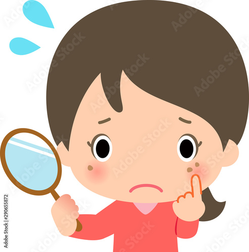シミを気にする鏡を持った若い女性