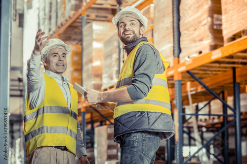 Positive delighted workers looking in one direction
