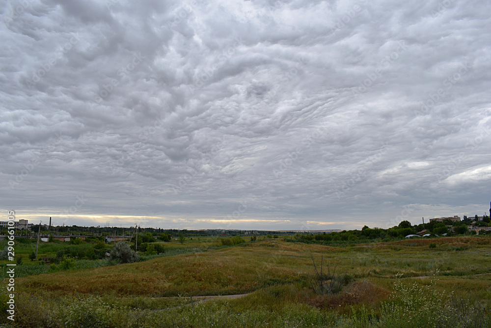 Landscape with sky covered by bizarre clouds. Landscape with sky covered by bizarre clouds.