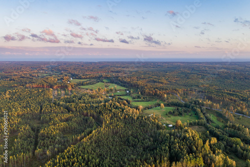 Aerial view of river among the forest. Summer nature landscape. Sunset.