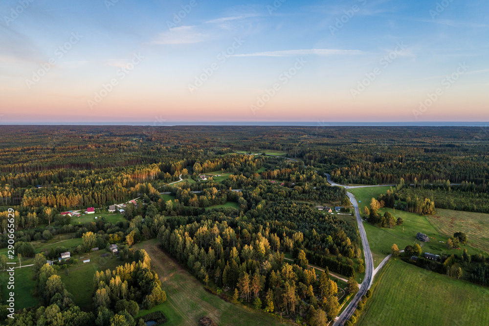 Aerial view of amazing sunset at summer season. Nature landscape. Fields and trees.
