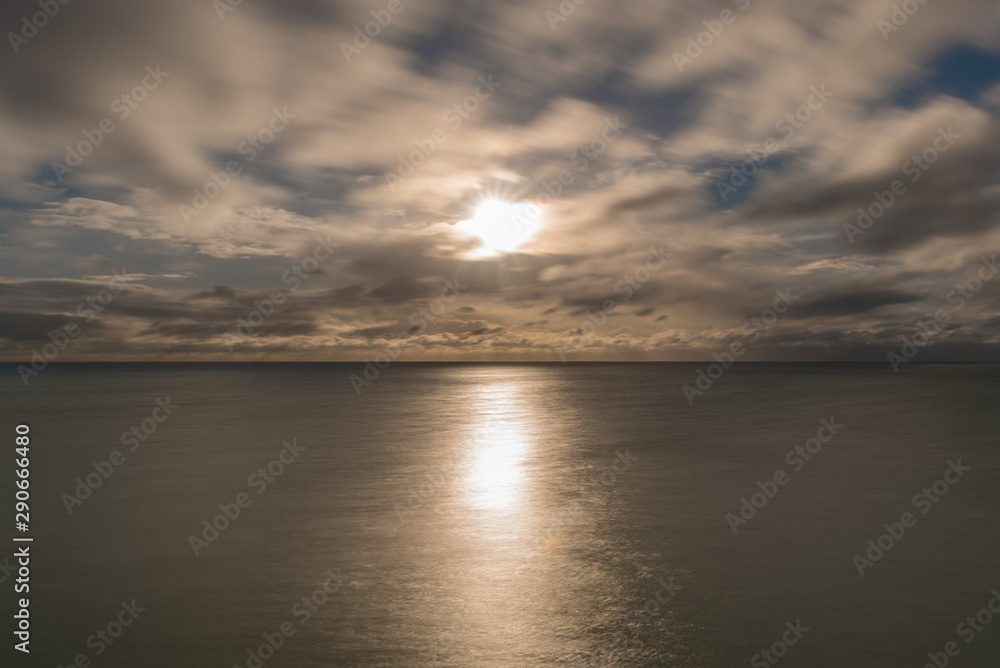 Long exposure of the sun, clouds and the sea in England, UK.