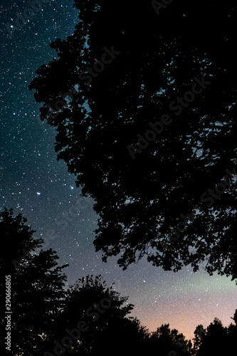 Overhead milky way with stars in clear summer night. Old barn house. Country side.