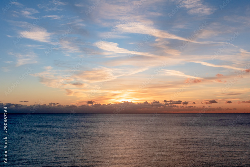 The sun set over the clouds and casts beautiful golden colours across the skies. The sun set over the clouds and casts beautiful golden colours across the skies.