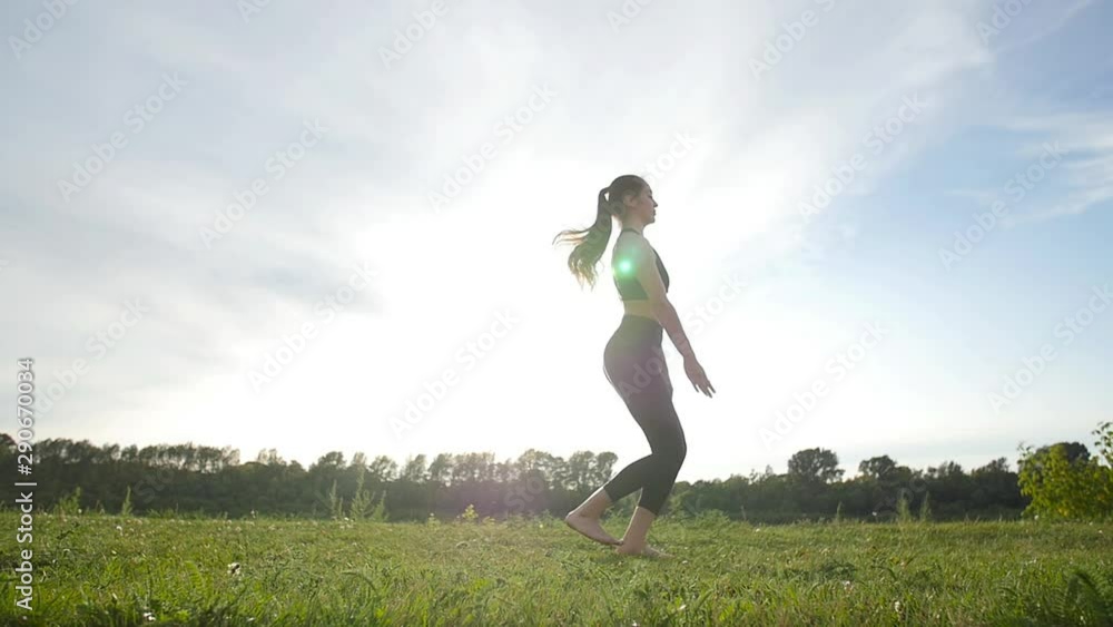 concept of health, stretching and healthy lifestyle. Young female athlete sitting on an exercising and stretching in a park at sunset. concept of health, stretching and healthy lifestyle. Young female athlete sitting on an exercising and stretching in a park at sunset.