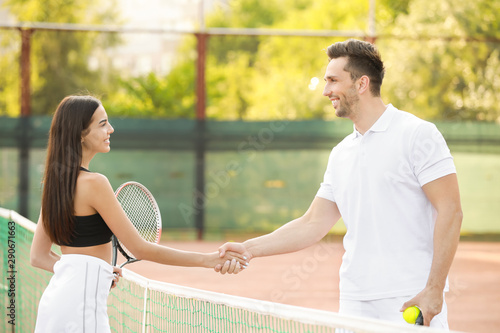 Young couple shaking hands ...