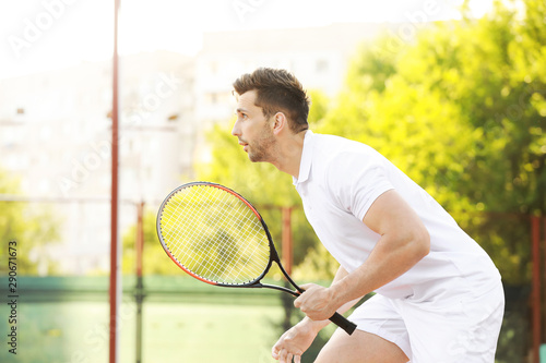 Young man playing tennis on court © Pixel-Shot