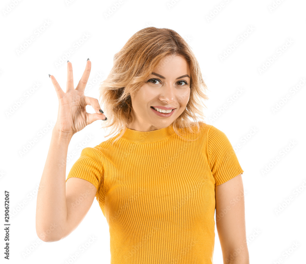 Portrait of beautiful woman showing OK on white background Portrait of beautiful woman showing OK on white background