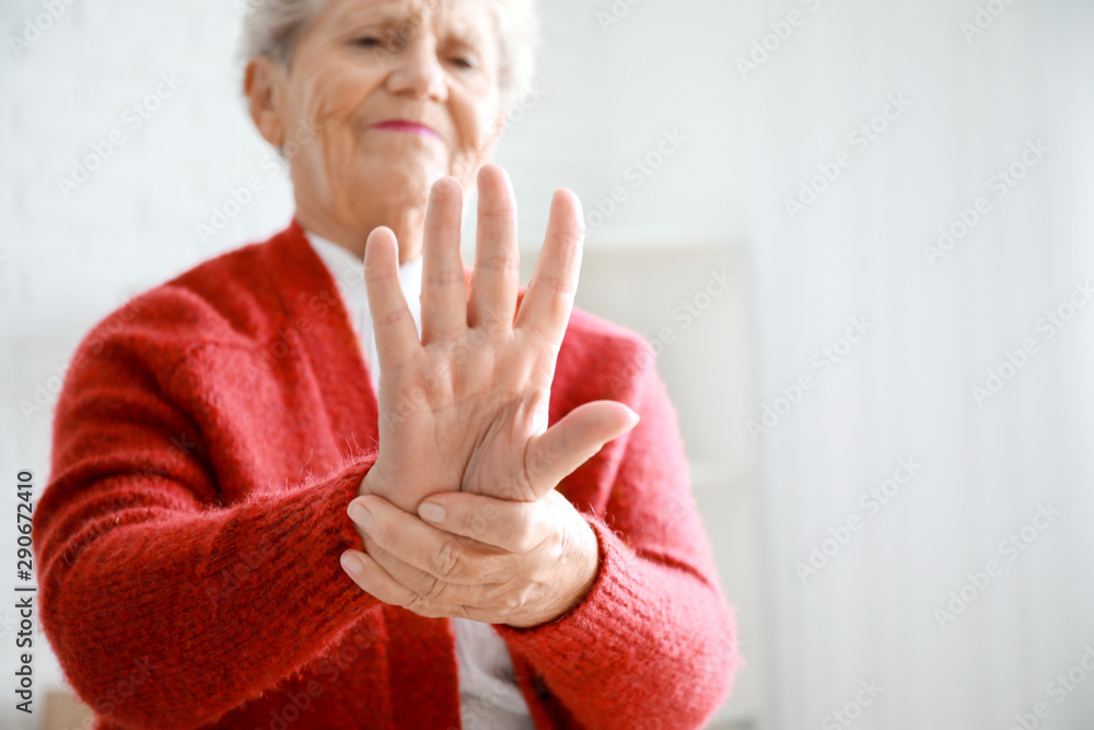 Senior woman suffering from pain in wrist at home, closeup Senior woman suffering from pain in wrist at home, closeup