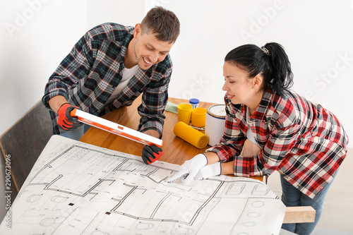 Happy couple doing repair i...