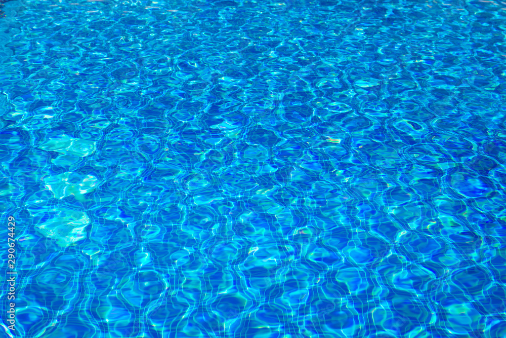 Transparent clear water in the pool. blue mosaic tiles, water texture. Blue water pool bottom background. Transparent clear water in the pool. blue mosaic tiles, water texture. Blue water pool bottom background.