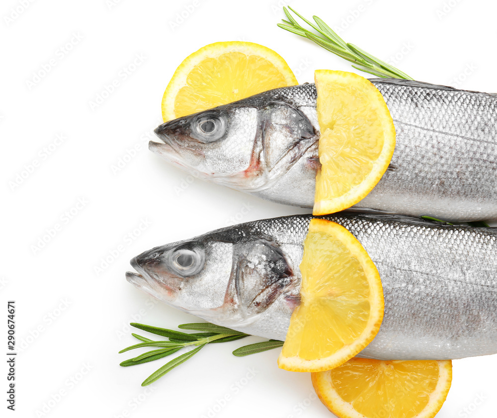 Fresh seabass fish with rosemary and lemon on white background Fresh seabass fish with rosemary and lemon on white background