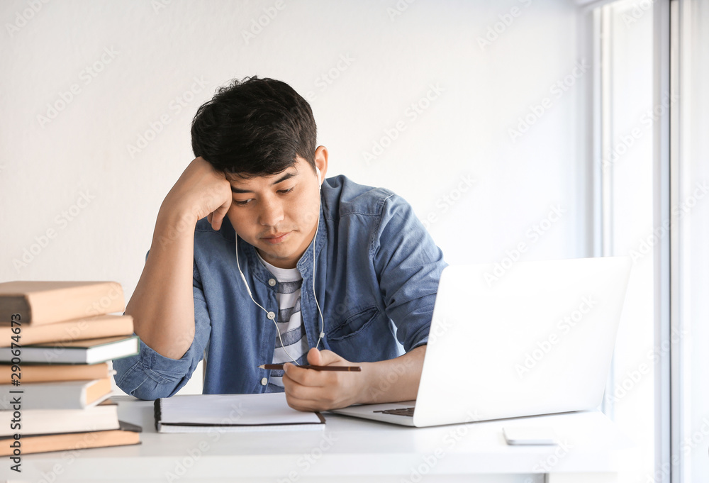 Asian student preparing for exam at home Asian student preparing for exam at home