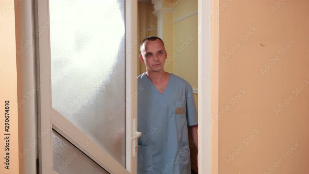 man doctor opens the door and invites the girls into the office man doctor opens the door and invites the girls into the office
