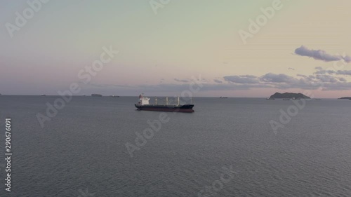 General cargo ship at the anchorage in the evening, Far East, Russia photo