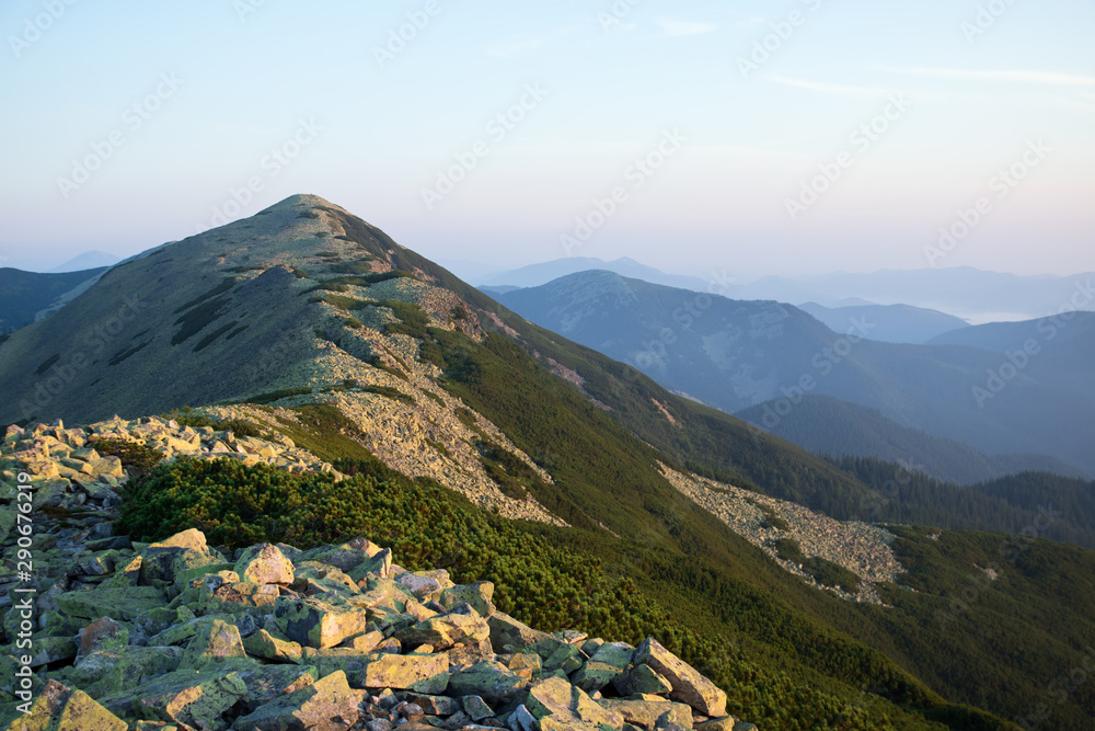 Fototapeta premium green stones mountain range in the morning light
