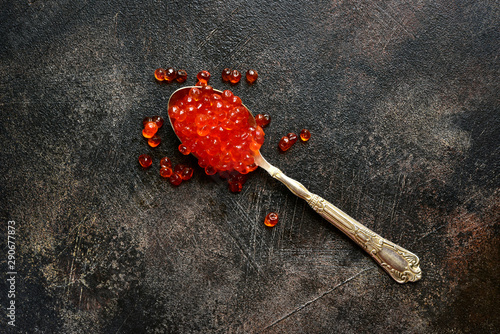 Natural organic red salmon caviar on a spoon.Top view with copy space.