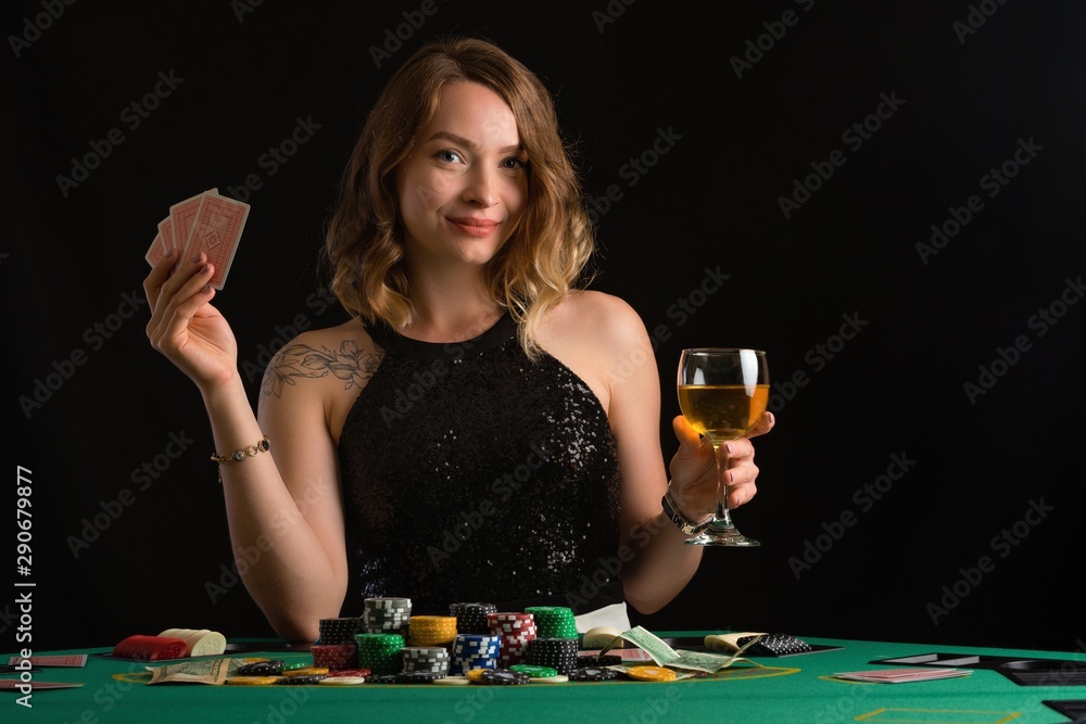 The girl plays in a casino. Game and risk. Fortuna. Poker and card games The girl plays in a casino. Game and risk. Fortuna. Poker and card games
