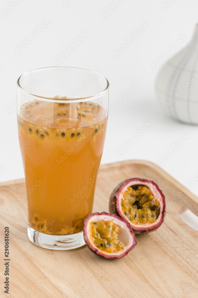 Glass of passion fruit tea, Refreshing summer drink and dessert on wood plate and minimal style background. Glass of passion fruit tea, Refreshing summer drink and dessert on wood plate and minimal style background.