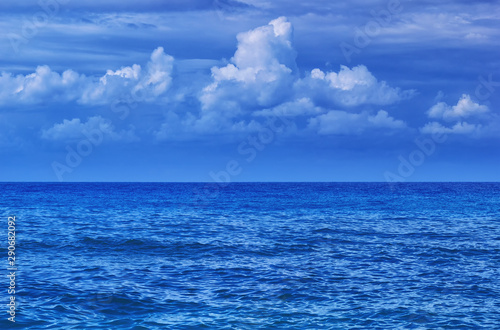 Blue sea view with clouds. Weather on sea. Beautiful nature background with water surface and sky. Summer seascape panorama