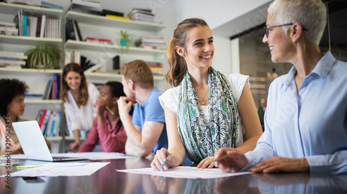 Cheerful coworkers in office during company meeting