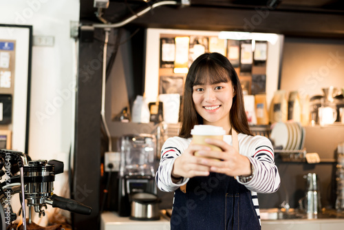 Young asian women barista smiling at coffee shop counter background, start up small business owner food and drink concept.