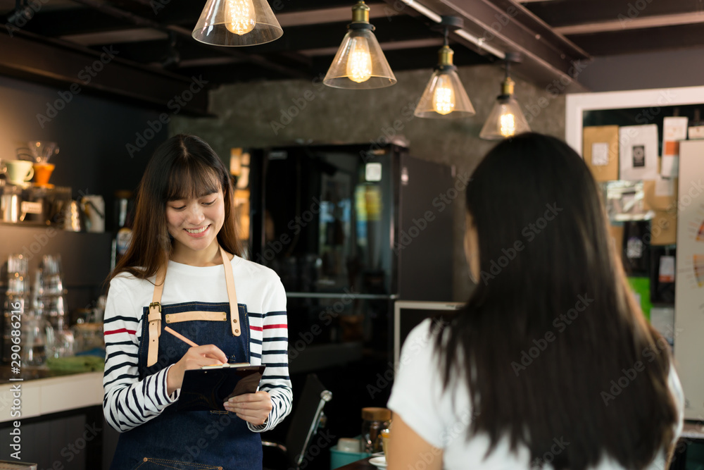 Young asian women barista get orders at the coffee shop,start up small business owner food and drink concept. Young asian women barista get orders at the coffee shop,start up small business owner food and drink concept.