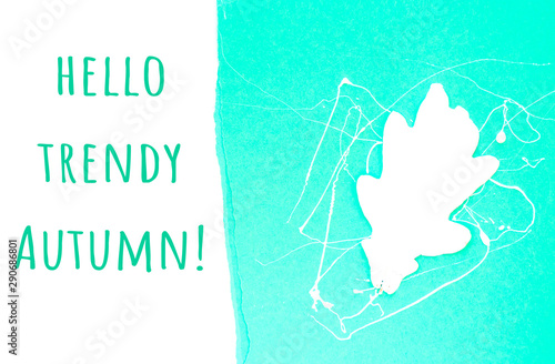 Neo mint color trendy background with white oak leaf and copyspace. Hello autumn concept. photo