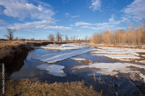 Spring landscape river  forest and clouds on a blue sky