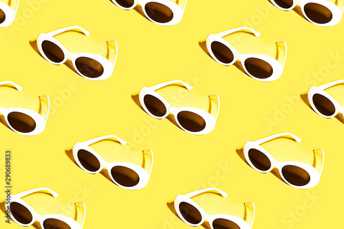 White sunglasses pattern on yellow background.
