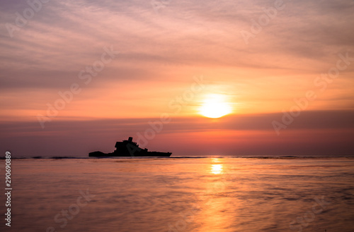 Abandoned ship in the sea during sunset © sidoy
