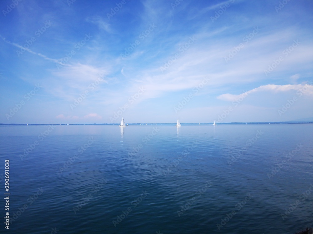 boats in the water on sunny day at the Chiemsee in Bavaria, Germany