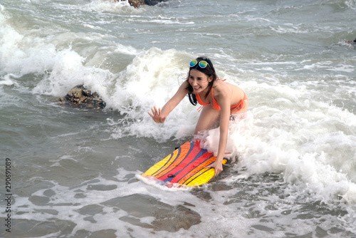 Pretty Asian woman in bikini with surf board on fun , Surfboard is water sport lessons and beach swimming activity on summer vacation. © topten22photo