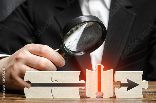Fotografie Businessman explores a wrong puzzle piece